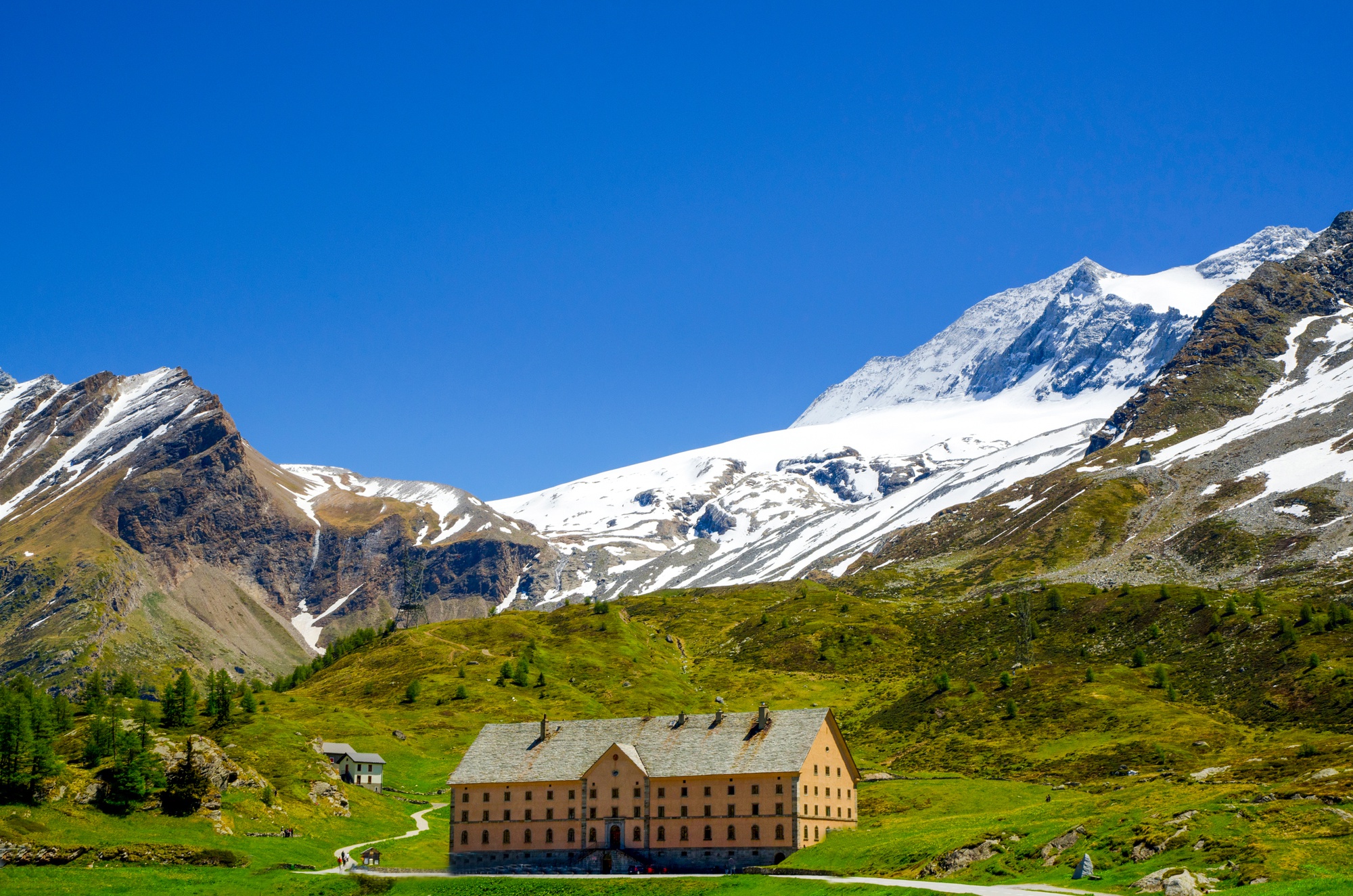house-surrounded-by-rocky-mountains-covered-greenery-snow-valais-switzerland