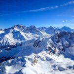 Snowy mountain peaks against a blue sky.